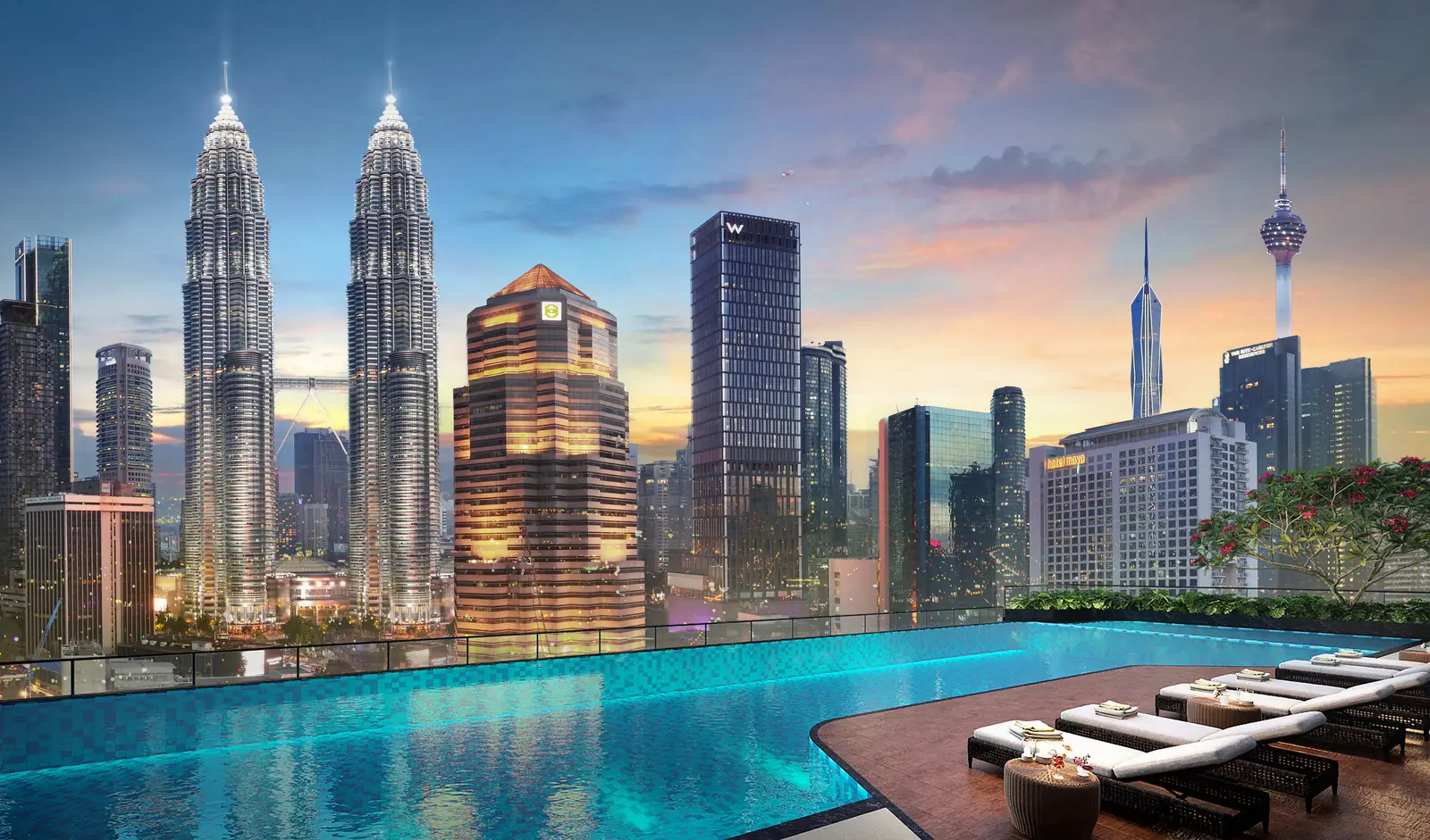 Rooftop infinity pool at Sutera Suites overlooking the Petronas Twin Towers at dusk